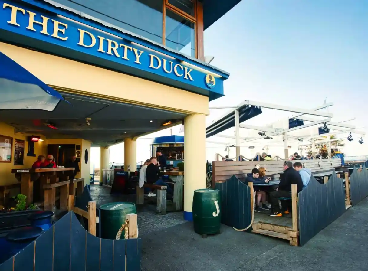 The Dirty Duck bar with guests on the outdoor terrace